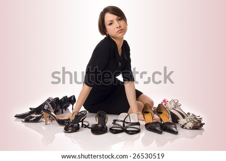 Beautiful girl with lot of shoes around her