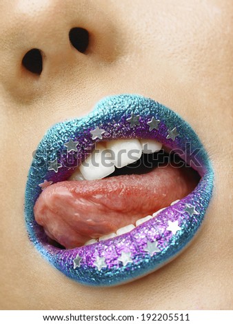 Beauty photo (close-up) of turquoise/purple female lips - star on lips