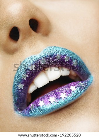 Beauty photo (close-up) of turquoise/purple female lips - star on lips