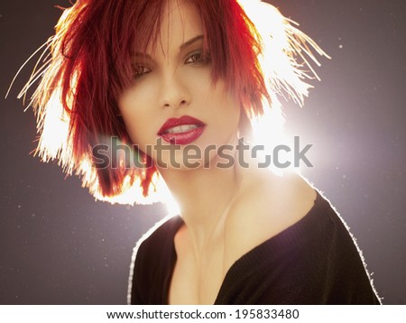 Red Hair. Fashion Woman Portrait. Beauty Model Girl with Luxurious Hair, Make up and Accessories. Hairstyle. Wavy Hair Extensions Concept. Holiday Makeup. Red lipstick