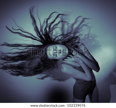 Good girl with flowing hair on a gray background.