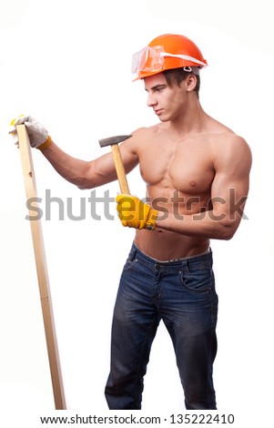 Muscular young worker in an orange helmet with a hammer on a white background.