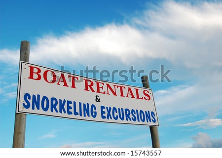 Sign advertising boat rentals and snorkeling excursions.