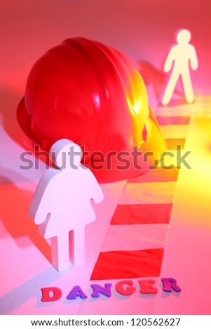 Dangerous working environment.  Hard,hat,chevron and warning light with two human figures