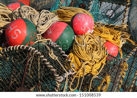 Deep sea fishing equipment on a boat in the harbor, fishing nets, buoys, lobster pots and robes.  Fishing industry of the Western Cape, South Africa.