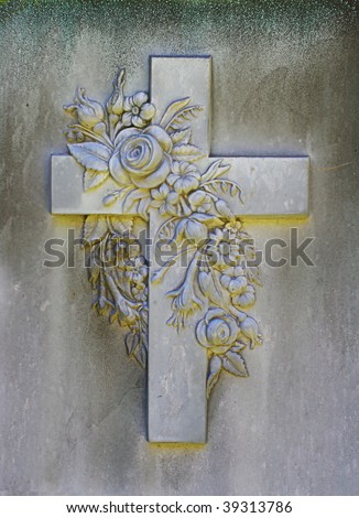 Grunge Stone Cross and flowers carving from a grave marker