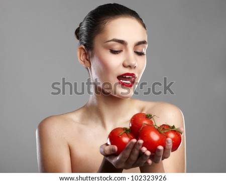 smiling woman with a tomatos in hand