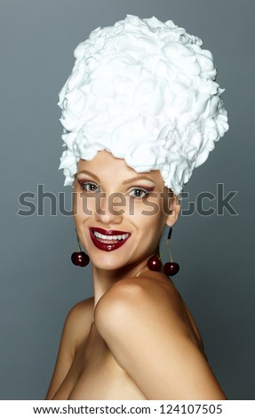 beautiful naked woman with red lips with cream and cherries on her head isolated on white