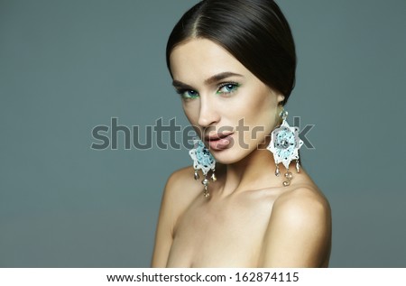 brunette girl with long hair in a luxurious designer decorations in the studio