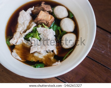 pork noodle in black herb soup with meat ball