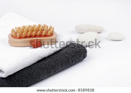 Spa still-life with black and white towels and white stones
