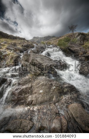 Rhaeadr Idwal Waterfall, on the route up to Cwm Idwal and The Devils Kitchen in Snowdonia, North Wales. The waters of Afon Idwal tumble over the rocks as they descend to the floor of the Ogwen Valley.