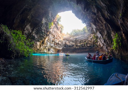 Kefalonia, Greece - August 11, 2015: Melissani is a cave on the island of Kefalonia. Rowboats lead tourists inside the cave, to admire the stalactites and the incredible color-changing water.