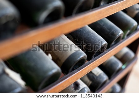 Some Very Old And Dusty Wine Bottles In A Wine Cellar
