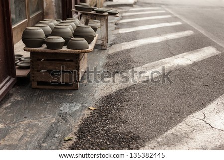 some crockery arranged on the street in a typical italian artisan shop