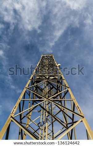 a communication tower (microwave, tv or telephone) over a blue sky