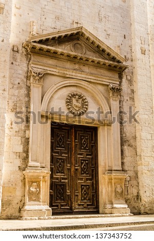 a beautiful wooden portal of a church in south italy
