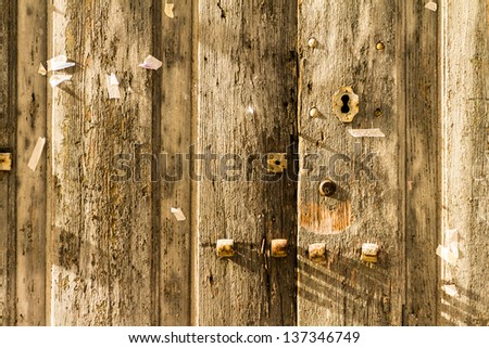 an old, rusty wooden door with lot of scratches and peeling paint