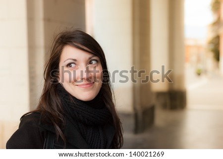 a beautiful smiling girl under a colonnade in south italy