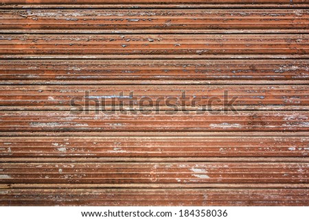 close up shot of a rusty and scratched roll up door