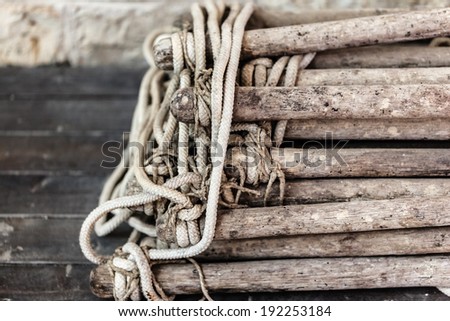 close up shot of an old and worn rope ladder
