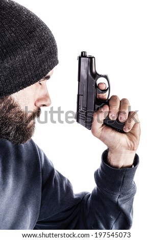 a bearded criminal or an undercover cop with a pistol and wearing a beanie hat isolated over white