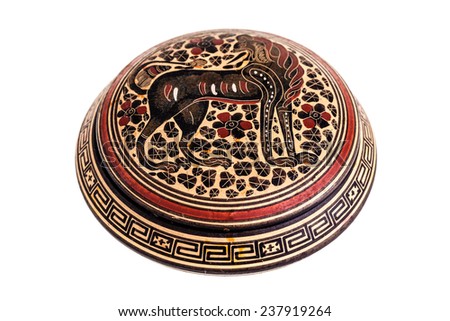 a small round ancient decorated ceramic box isolated over a white background