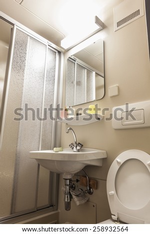 a small bathroom with a wc, a sink and a shower cabin
