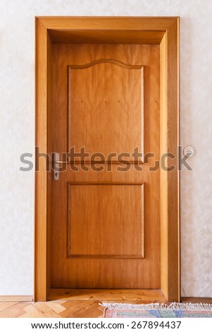 a simple wooden door in the interior of a house