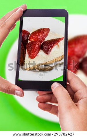 a woman using a smart phone to take a photo of a delicious cake
