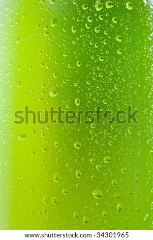 Close up shot of a wet bottle with tropical drink