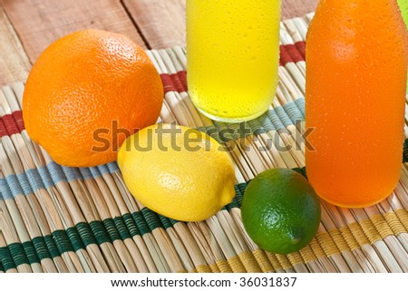 Overhead shot of cold drinks with fruits around them
