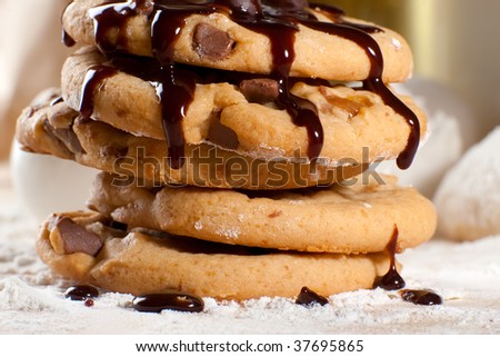 Stack of freshly cooked cookies with melting chocolate on them