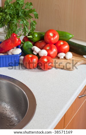 Heap of fresh veggies next to the kitchen sink