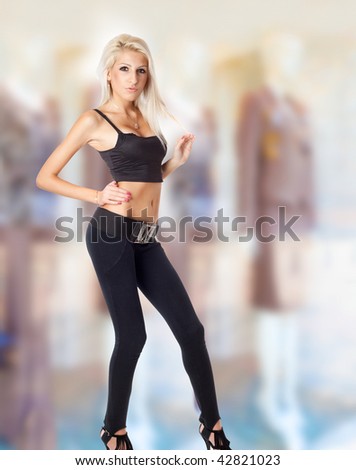 Blond lady in front of stores for cloths