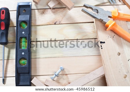 A lot of work tools scattered over wooden planks