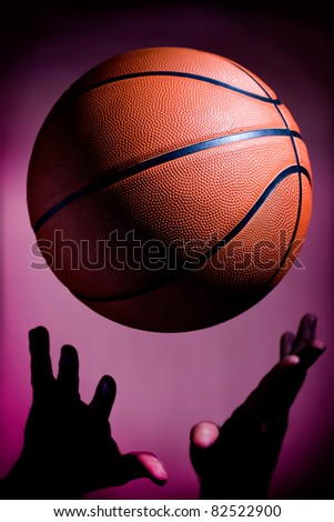 A man playing basketball is a bout to catch the ball
