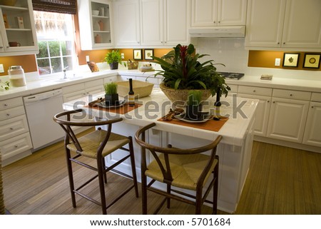 Kitchen with decorated island and sunlight.