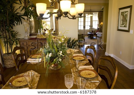 Festive dining table with a chandelier and luxurious decor.