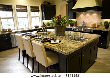 Kitchen and island with modern stove.