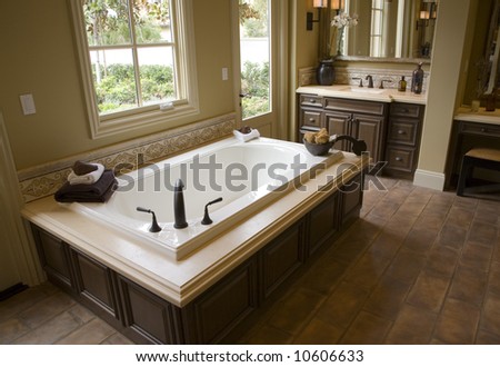 Designer bathroom with a modern tub and tile floor.