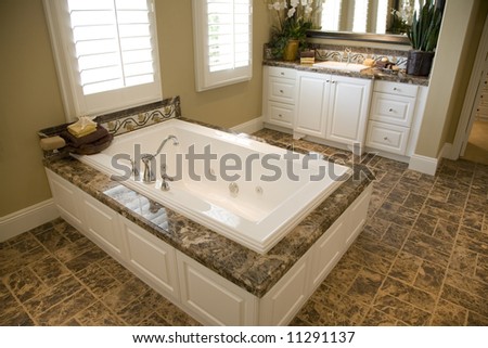 Upscale bathroom with a modern tub and tile floor.