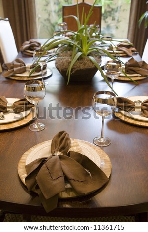 Festive dining table with luxurious dinnerware and decor.