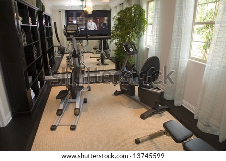 Luxury home gym with modern exercise equipment.
