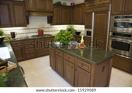 Modern designer kitchen with tiled floor.