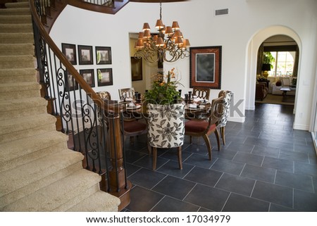 Dining room with luxury home stairway.