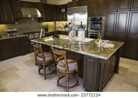 Modern kitchen with a tile floor and granite island.