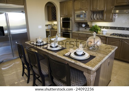 Luxury home kitchen with a granite top island.