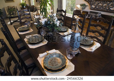 Dining table with luxury tableware and furniture.