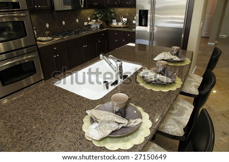 Luxury kitchen with a granite breakfast counter.
